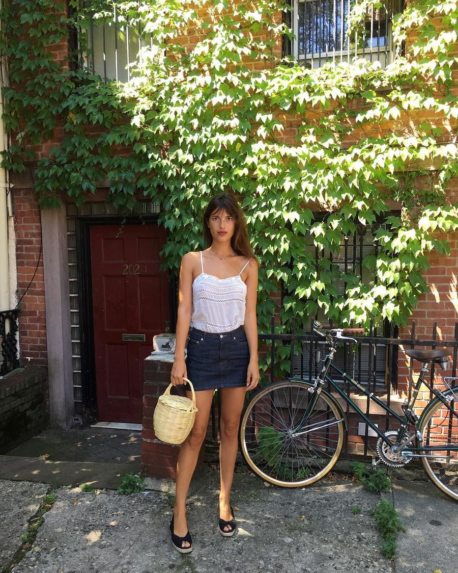 Jeanne Damas Summer Style wearing jean mini skirt and wicker basket bag