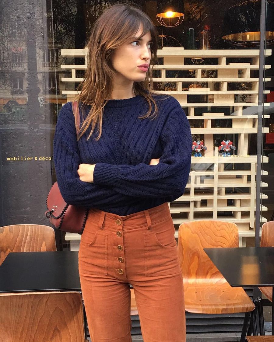 Jeanne Damas fall style with navy sweater and orange high-waisted pants