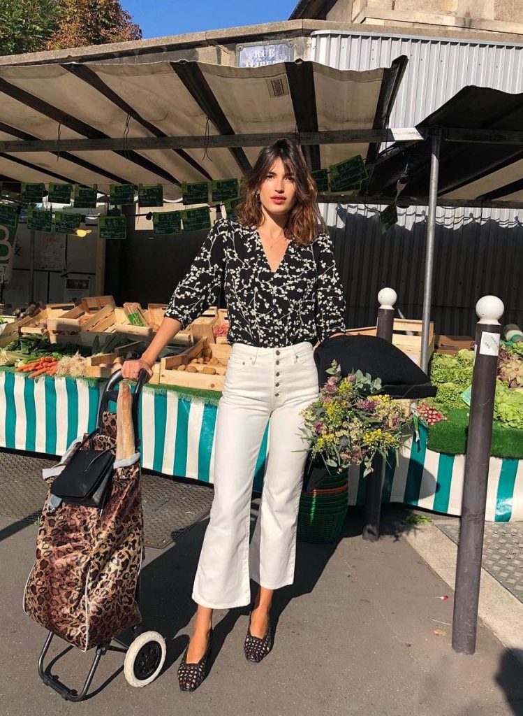 Black and White Wrap Top with White Jeans Outfits Ideas Jeanne Damas at a Parisian Market Outdoors