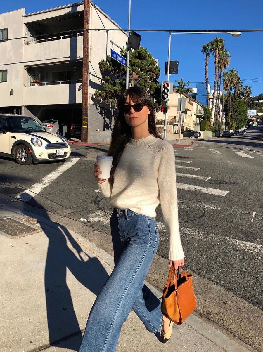 Cozy white sweater and wide leg blue jeans with camel leather bag Leia Sfez French Girl Spring style outfit