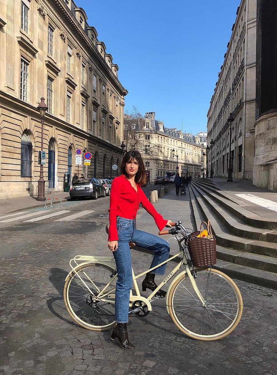Jeanne Damas red sweater and blue jeans with black boots French Girl Spring outfit ideas