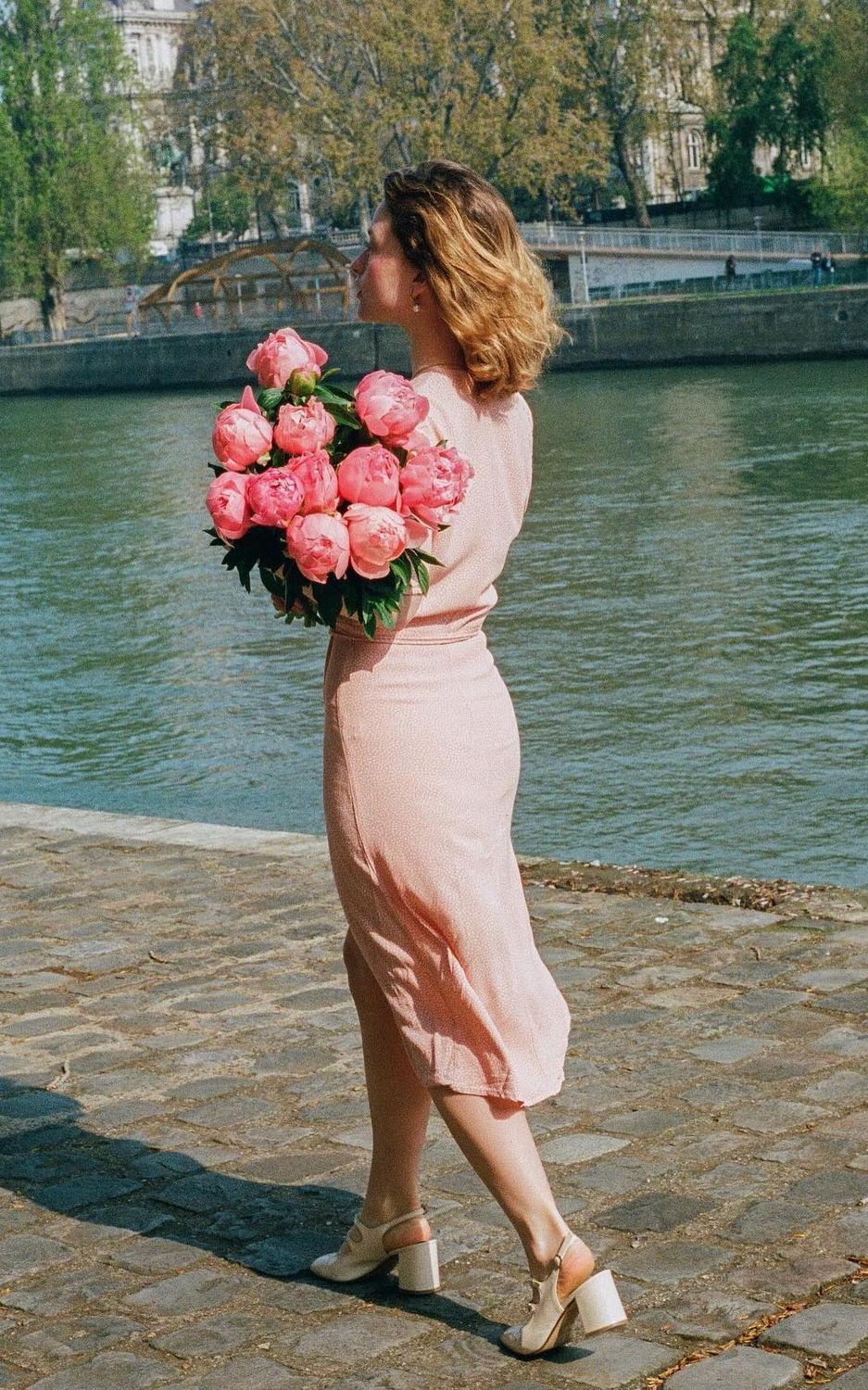 Parisian spring outfits pink wrap dress camilleyolaine